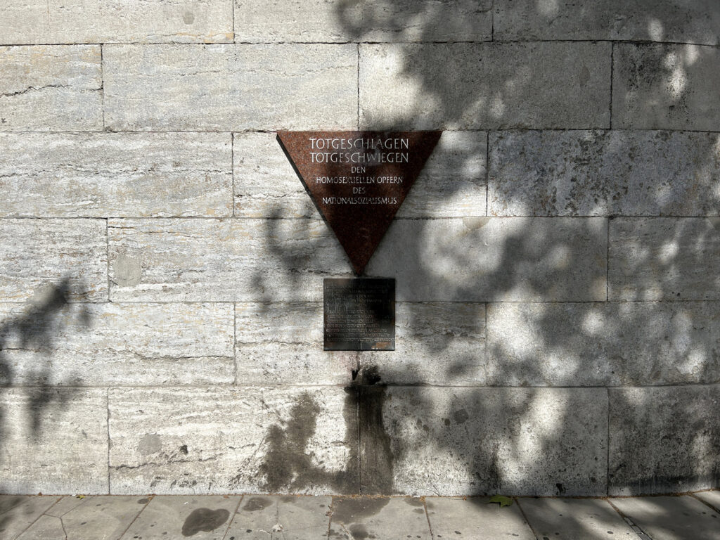 The pink triangle memorial on the wall of the Nollendorfplatz subway station.