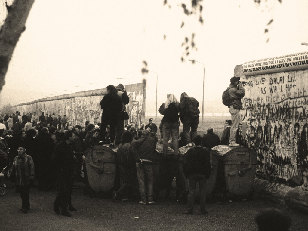 A crowd of West German citizens gathers at the newly created opening in the Berlin Wall at Potsdamer Platz.