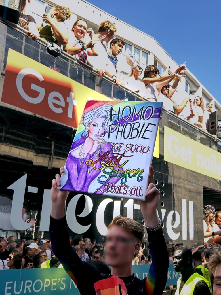 A guy with a picket sign at CSD Berlin 2026.